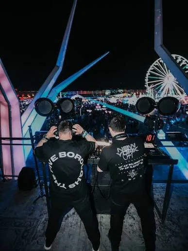 Two DJs overlooking a festival audience