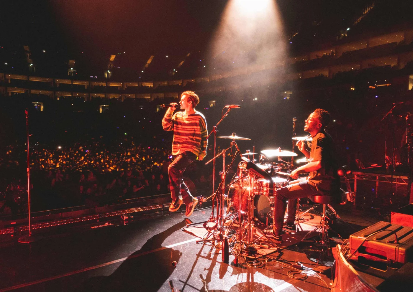 A band performing to an audience in a theatre