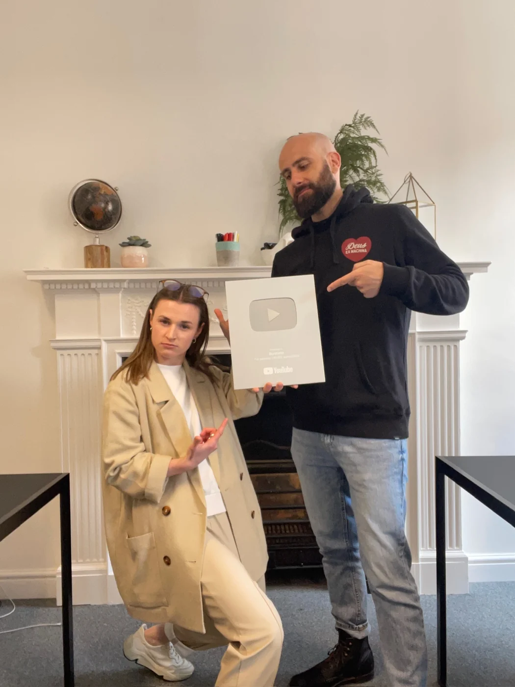 Maddy and Alex holding a YouTube creator award