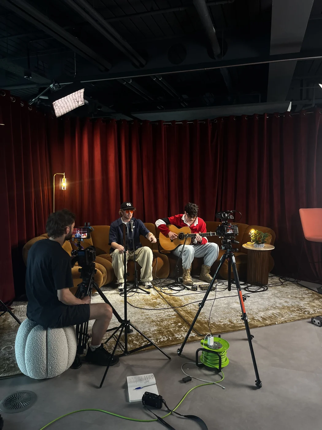 Filming a live performance in front of red curtains