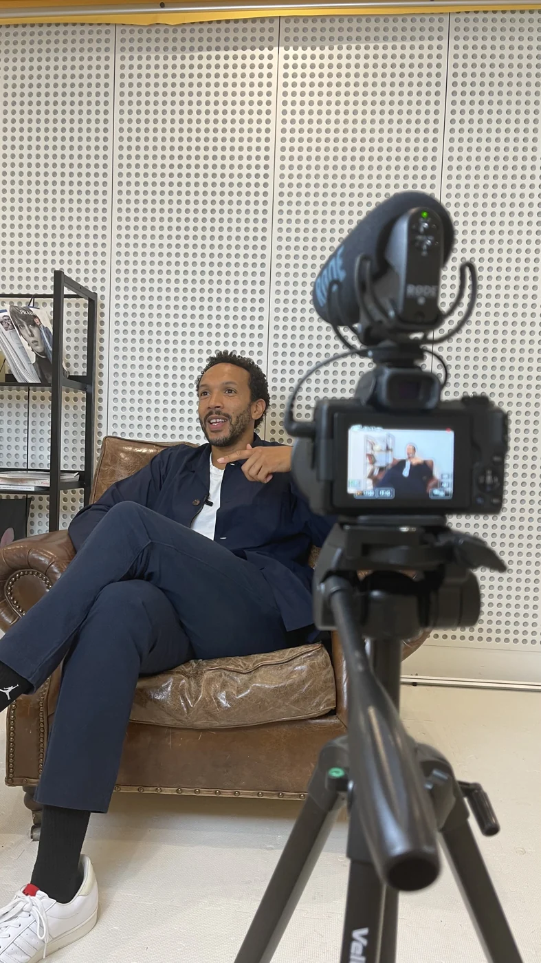 Filming a guest seated in a recording studio