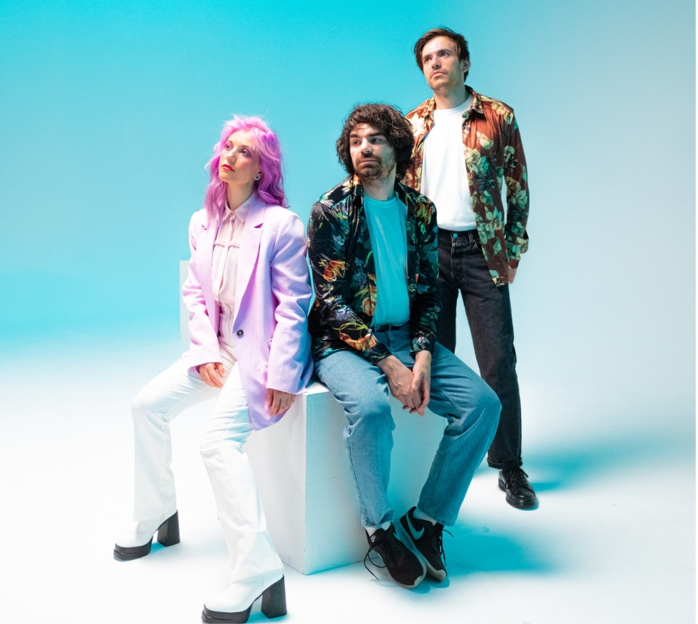 Band photographed against a blue background